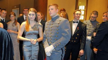 Kenzie Stepanik and Army Cadet Andrew Irwin listen to instructions before the Grand March.