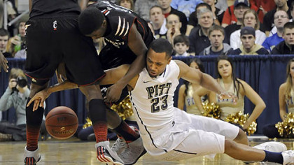 Trey Zeigler gets called for a foul as he reaches for a loose ball against Cincinnati's Shaquille Thomas Monday in the first half.