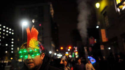 Damian Nunimaker of Jefferson Hills watches a band play Monday evening while wearing 2013 glasses during the city's First Night New Year's Eve festivities Downtown.