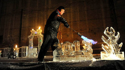 Rich Bubin of Ice Creations applies a blow torch to a 2013 ice sculpture Monday during Pittsburgh's First Night New Year's Eve festivities.