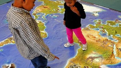 R.J. Bernard, 5, and his sister Rielle, 2, scrutinize an unusually large map of the world at the National Children's Museum.