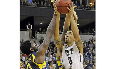 Pitt's Cameron Wright drives to the net against Marquette's Jamil Wilson in the first half this afternoon at the Petersen Events Center.
