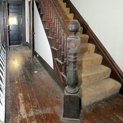 The entryway has original woodwork.
Original interior wood shutters cover most of the windows.
