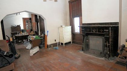 The 16- by 15-foot living room features the largest and most intricate of the fireplaces.
