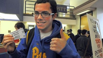 Frank Paciaroni, a freshman at Pitt, shows off the tickets he scored to the Stephen Colbert event Friday.