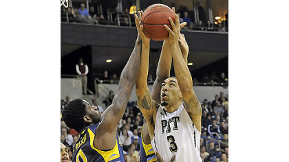 Pitt's Cameron Wright drives to the hoop against Marquette's Jamil Wilson in the first half of Marquette's 74-67 overtime victory.

