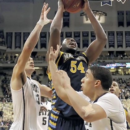 Marquette's Davante Gardner drives to the hoop against Pitt's Steven Adams and James Robinson in the Golden Eagles' Big East win.