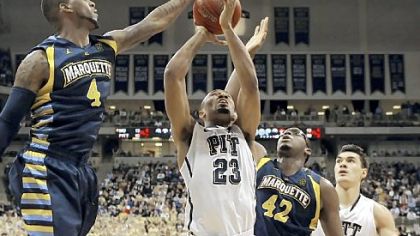 Marquette's Todd Mayo blocks a shot by Pitt's Trey Zeigler in the first half Saturday at Petersen Events Center.