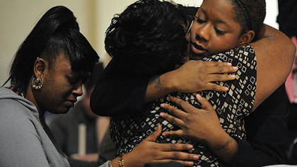 
Ka'Sandra Wade's friends Sheena Davis, left, of Wilkinsburg and Stacha Morris, right, of Homewood hug Ms. Wade's mother Sharon Jordan of Aliquippa at a vigil Saturday at Eastminster Presbyterian Church in East Liberty.