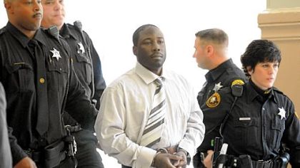 Ronald Robinson is escorted from Judge Kevin Sasinoski's courtroom for a lunch recess on the first day of his murder trial Thursday. He is accused of killing Penn Hills police officer Michael Crawshaw in December 2009.

