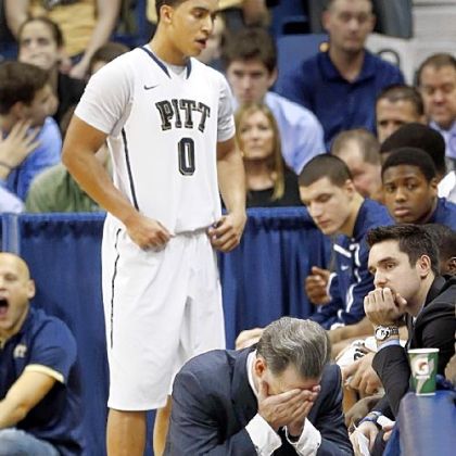 Pitt coach Jamie Dixon squats along the bench as time runs down in the overtime period Saturday against Marquette. The Panthers lost, 74-67, to drop to 1-3 in the Big East.