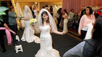 Courtney Seymour of Dormont turns to her family as she announces that she has found her wedding dress Sunday afternoon at the Center for Building Hope charity wedding gown sale at The Fez in Aliquippa.