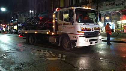 Workers from McGann & Chester tow away the green Buick that was the center of Sunday morning's chase that ended in Pittsburgh's South Side.

