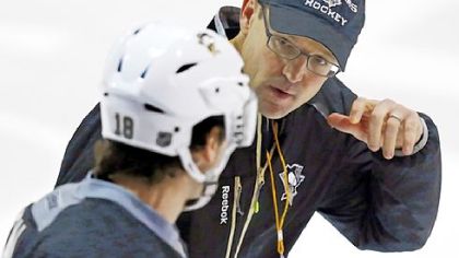 Penguins coach Dan Bylsma, right, talks with James Neal Sunday at practice.