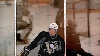Sidney Crosby is seen against his reflection during drills Sunday at the first day of Penguins training camp.
