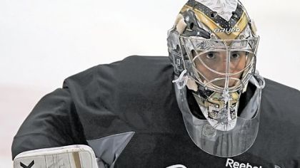 Penguins goalie Marc-Andre Fleury eyes up a slap shot at drills Sunday, the first day of Penguins camp.