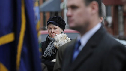 Gloria Szala a lifetime resident of the South Side listens to a press conference about public safety Tuesday on 16th and Carson Streets.  
