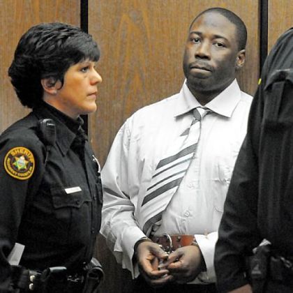 Ronald Robinson is escorted from Judge Kevin Sasinoski's courtroom for a lunch recess on the first day of his murder trial Thursday.
