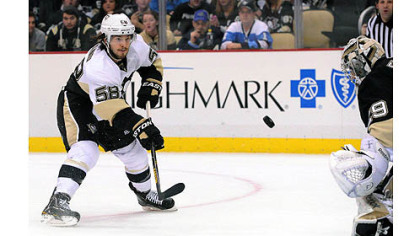 Kris Letang, member of the Penguins white team, scores in the first period of an exhibition scrimmage.


