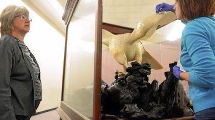 Carnegie Museum of Natural History intern Ashley Cox, 25, right, of the  cleans up the Japanese ivory eagle sculpture Friday while conservator Gretchen Anderson looks on.
