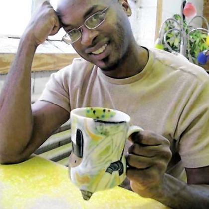 Chicago ceramist Kevin Snipes, with one of his mugs, will teach and speak here on Monday.
