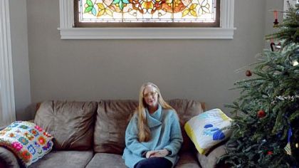 Kasey Connors of Wilkinsburg with a stained-glass window that was uncovered in a wall in one of her houses. She will speak about buying and restoring properties at 10 a.m. today at the Landmarks Housing Resource Center, Wilkinsburg.
