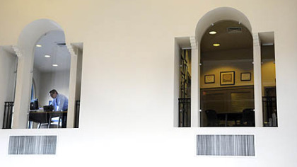 Windows in offices overlook the open interior of Desmone & Associates Architects in the defunct Pennsylvania National Bank building in Lawrenceville.
