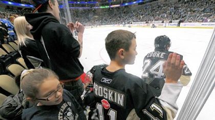 Pens fans line the glass watching practice before the scrimmage.