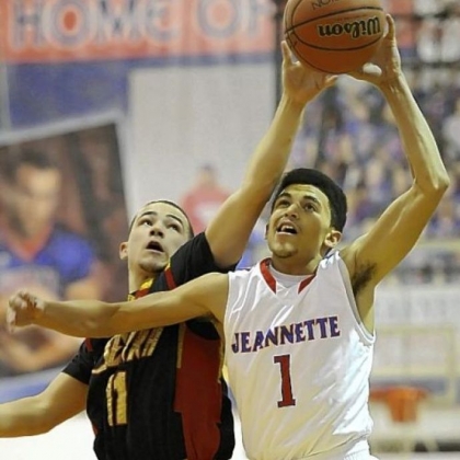 Jeannette's Julian Batts fights for the ball against Serra Catholic's Tyler Grebur Jan. 4. Batts' father, Adrian, is the Jayhawks coach.