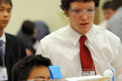 Partners Ziyang Liu, 17, center, and Alex Crellin, 17, of North Allegheny Senior High School, test their device during a technical problem-solving competition.