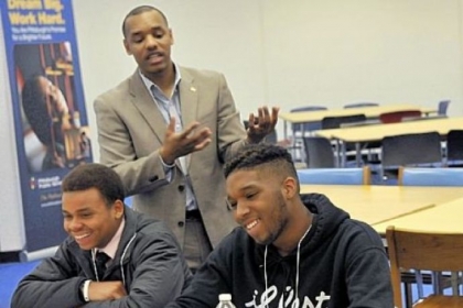 Charles Small, center, of the University of Pittsburgh, speaks to African-American male high school students Thursday. Listening are Chekaesha Neal, 17, and Mecca Wright, 16.