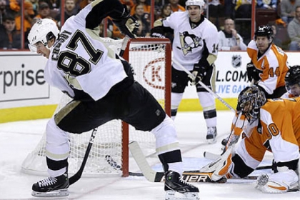 Philadelphia Flyers goalie Ilya Bryzgalov watches as the Penguins' Sidney Crosby (87) tries to control the puck during the first period.