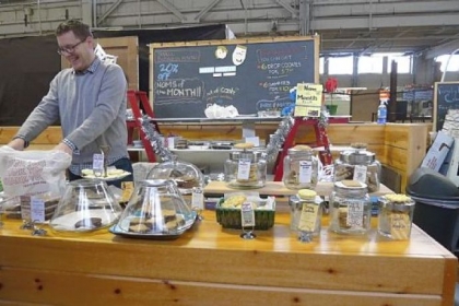 Matt Shroeder waits on a regular customer at Om Nom Bake Studio in the Pittsburgh Public Market in the Strip District. He says pie crust "really is a mixture of art and science."