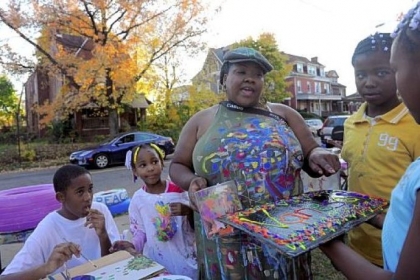 Sunny Littlejohn, 10, right, presents Vanessa German with a painting she made at the Art House.