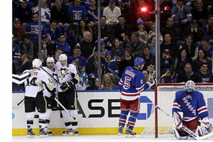 Rangers goalie Henrik Lundqvist, right, reacts while the Penguins' Pascal Dupuis, second from left, celebrates his goal with teammates Chris Kunitz, left, and Evgeni Malkin during the second period. The Rangers' Dan Girardi skates by.