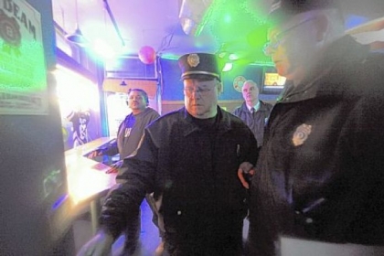 As part of the increased police presence on the South Side, fire Capt. James Flaherty, center, and police and building inspectors check inside Rumshakers on East Carson Friday night.