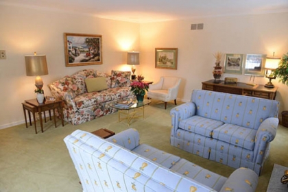 Off the marble-tiled entryway is the carpeted living room that measures 15 by 9 feet.