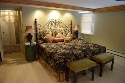 The 20- by-15-foot master suite features recessed lighting, a coved ceiling and floor-to-ceiling wardrobes.