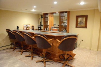 The basement has a wet bar with custom-made cabinetry, a full bath and a workout area.