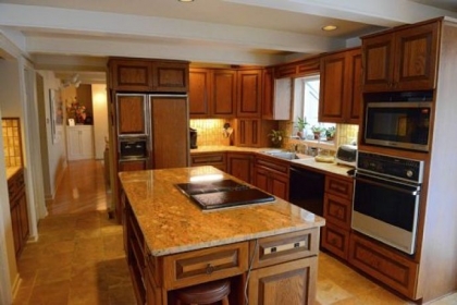 The granite counter top on the island in the kitchen was recently installed.