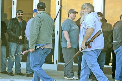 Patrons leave the Pennsylvania Gun Collectors Association gun show at the Expo Mart at Pittsburgh Mills near Tarentum with their rifles Saturday.