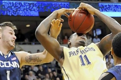Pitt's Dante Taylor pulls down a rebound against Connecticut's Enosch Wolf in the second half.