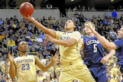 Pitt's James Robinson drives to the net against Connecticut's Niels Giffey in the first half at the Petersen Events Center Saturday.