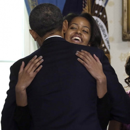 President Barack Obama hugs daughter Malia after taking the oath of office.