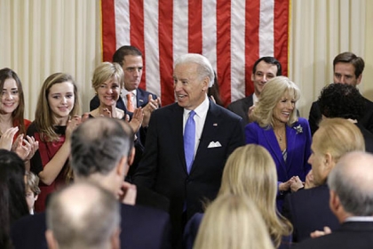 Vice President Joe Biden, with his wife Jill Biden, celebrate after taking the oath of office from Supreme Court Justice Sonia Sotomayor surrounded by family during an official ceremony at the Naval Observatory.