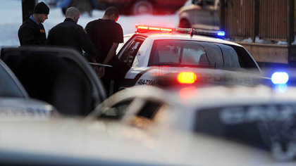 Police take a man into custody after surrounding a red building on 9th Avenue in Homestead while pursuing several men in connection with an unconfirmed abduction.