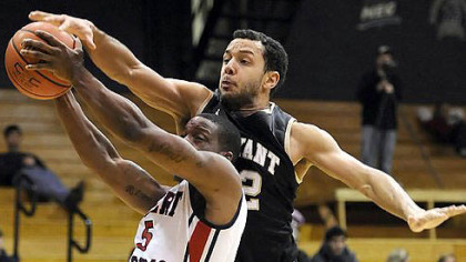 Robert Morris' Anthony Myers-Pate drives to the net as he is defended by Bryant's Dyami Starks in the first half Thursday night.
