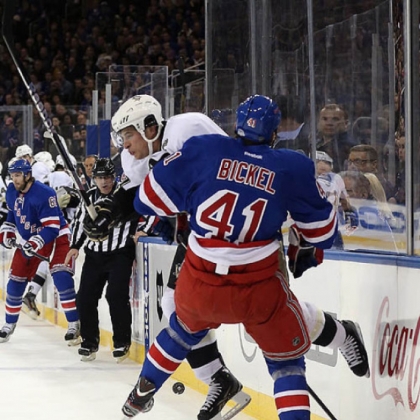 Sidney Crosby, rear, knocks the Rangers' Stu Bickel off the puck in the Penguins' 6-3 victory Sunday night at Madison Square Garden in New York.