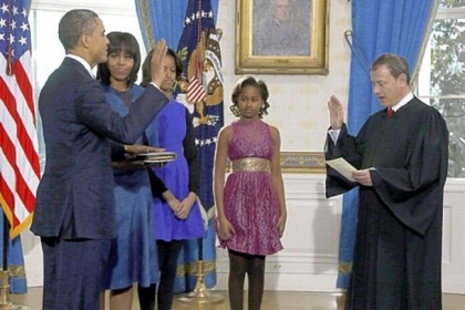 President Barack Obama is officially sworn in by Chief Justice John Roberts in the Blue Room of the White House on Sunday. Next to Mr. Obama are first lady Michelle Obama and daughters Malia and Sasha.