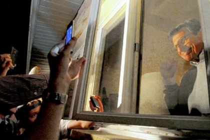 Joe Paterno acknowledges supporters gathered outside his house on Nov. 8, 2011, as the Penn State board pondered his fate.